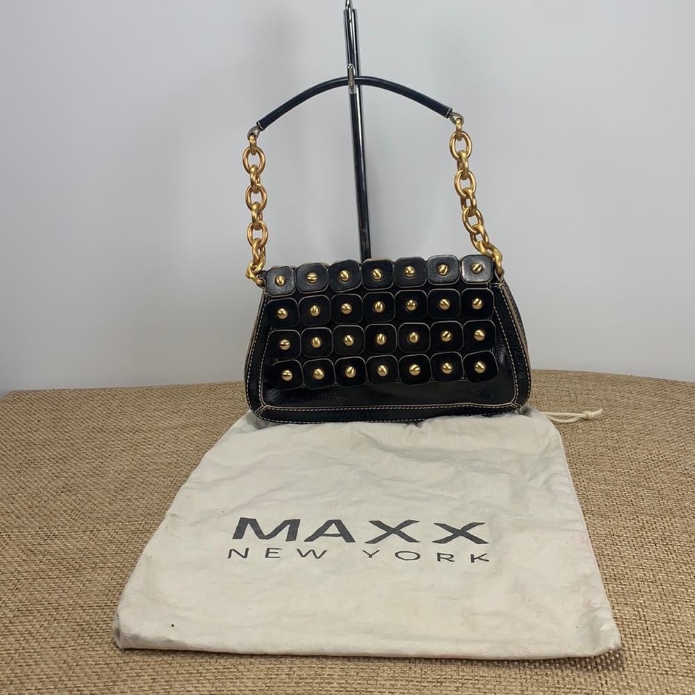 Black leather handbag with brass color hardware.